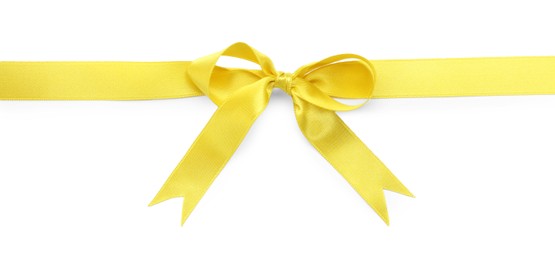 Yellow satin ribbon with bow on white background, top view