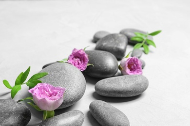 Photo of Composition with spa stones on grey background