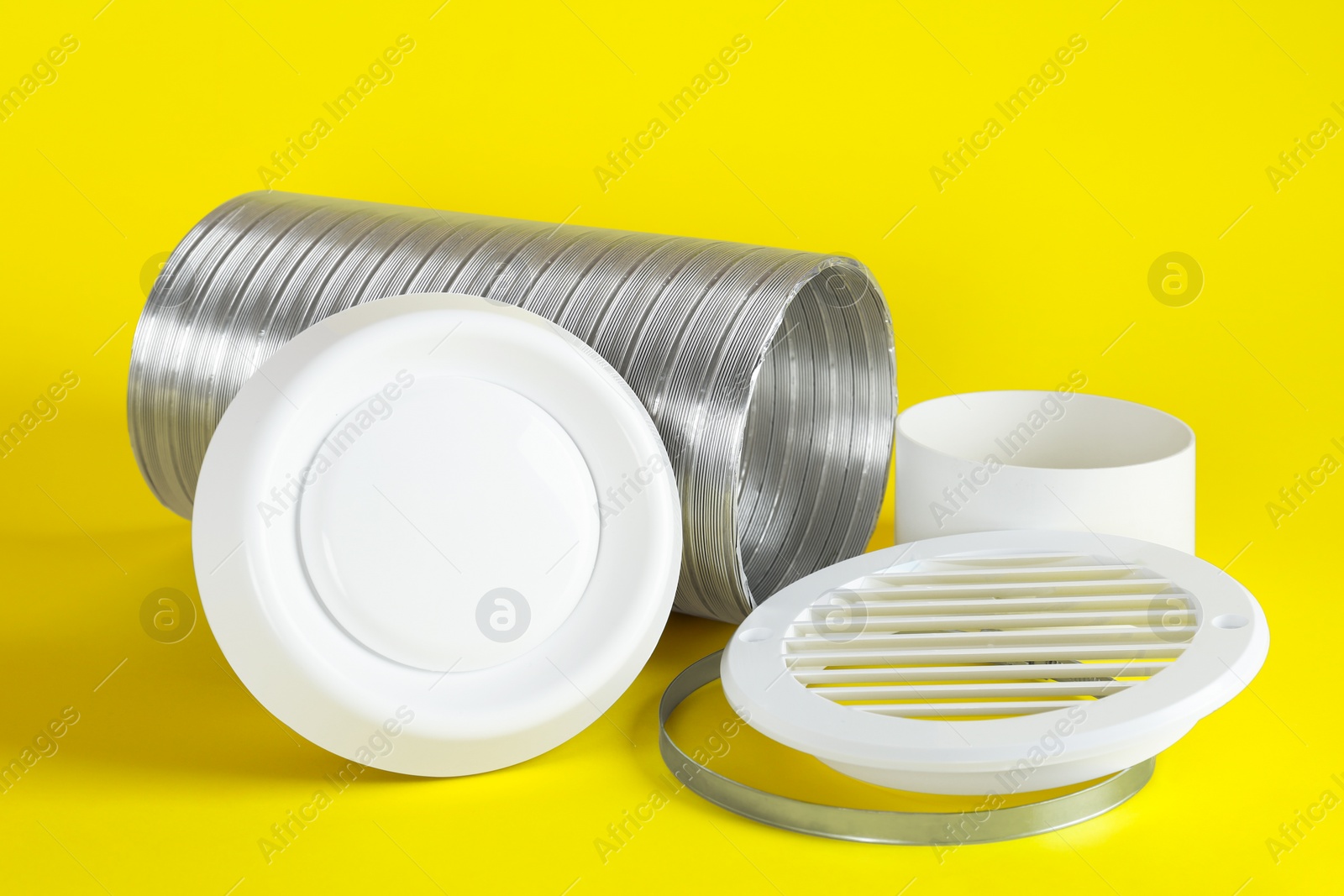 Photo of Parts of home ventilation system on yellow background