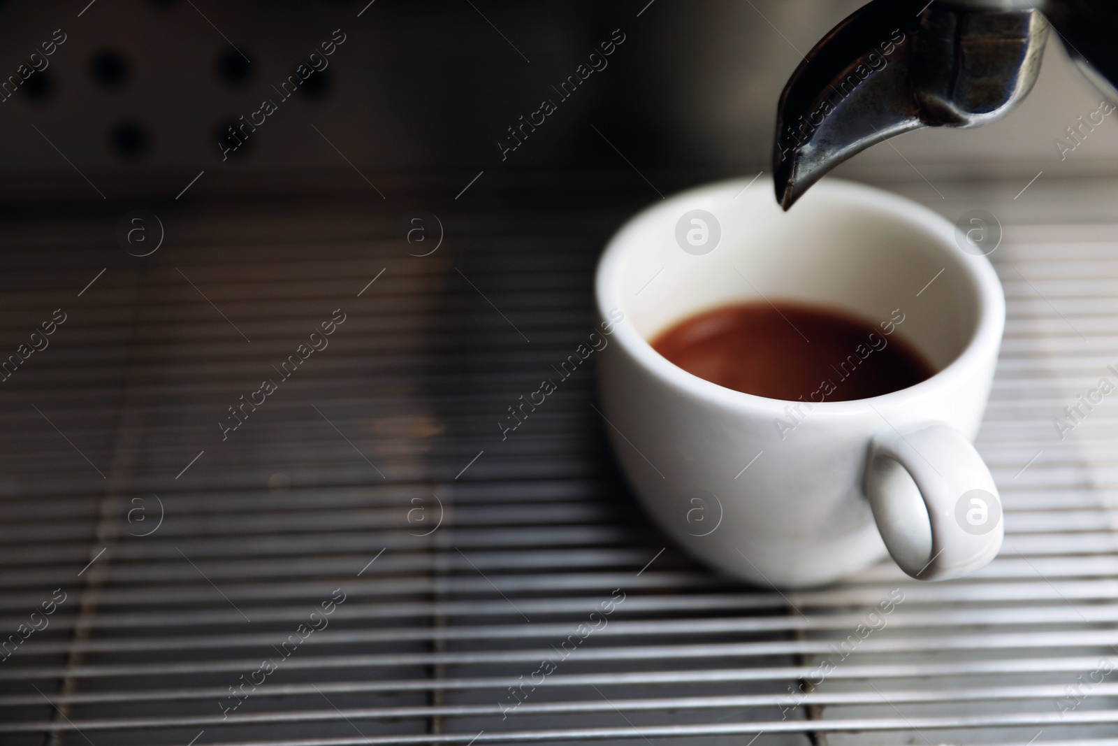 Photo of Modern coffee machine with cup on drip tray, closeup. Space for text