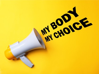 Abortion rights protest. Megaphone with slogan My Body My Choice on yellow background
