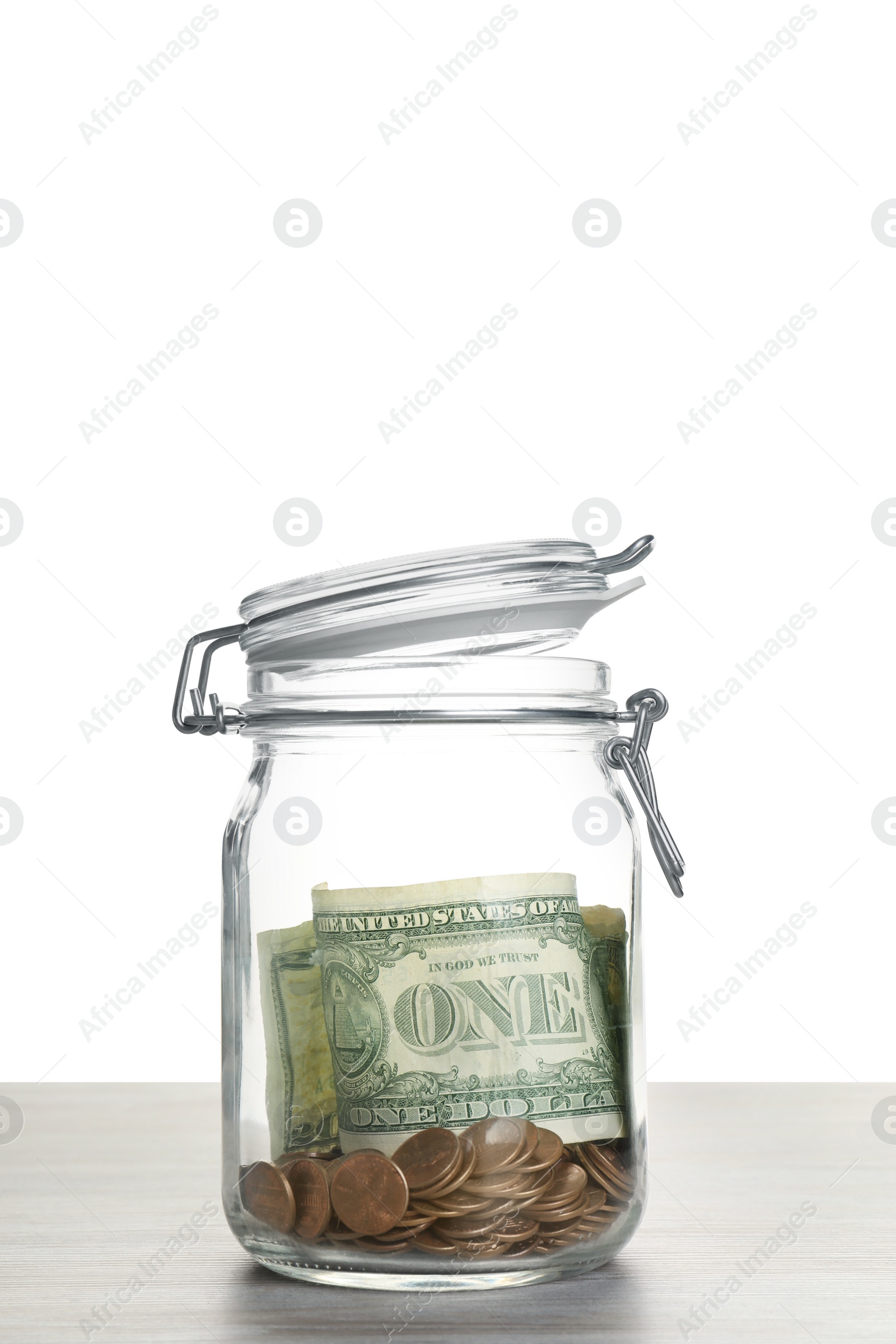 Photo of Tip jar with money on wooden table against white background