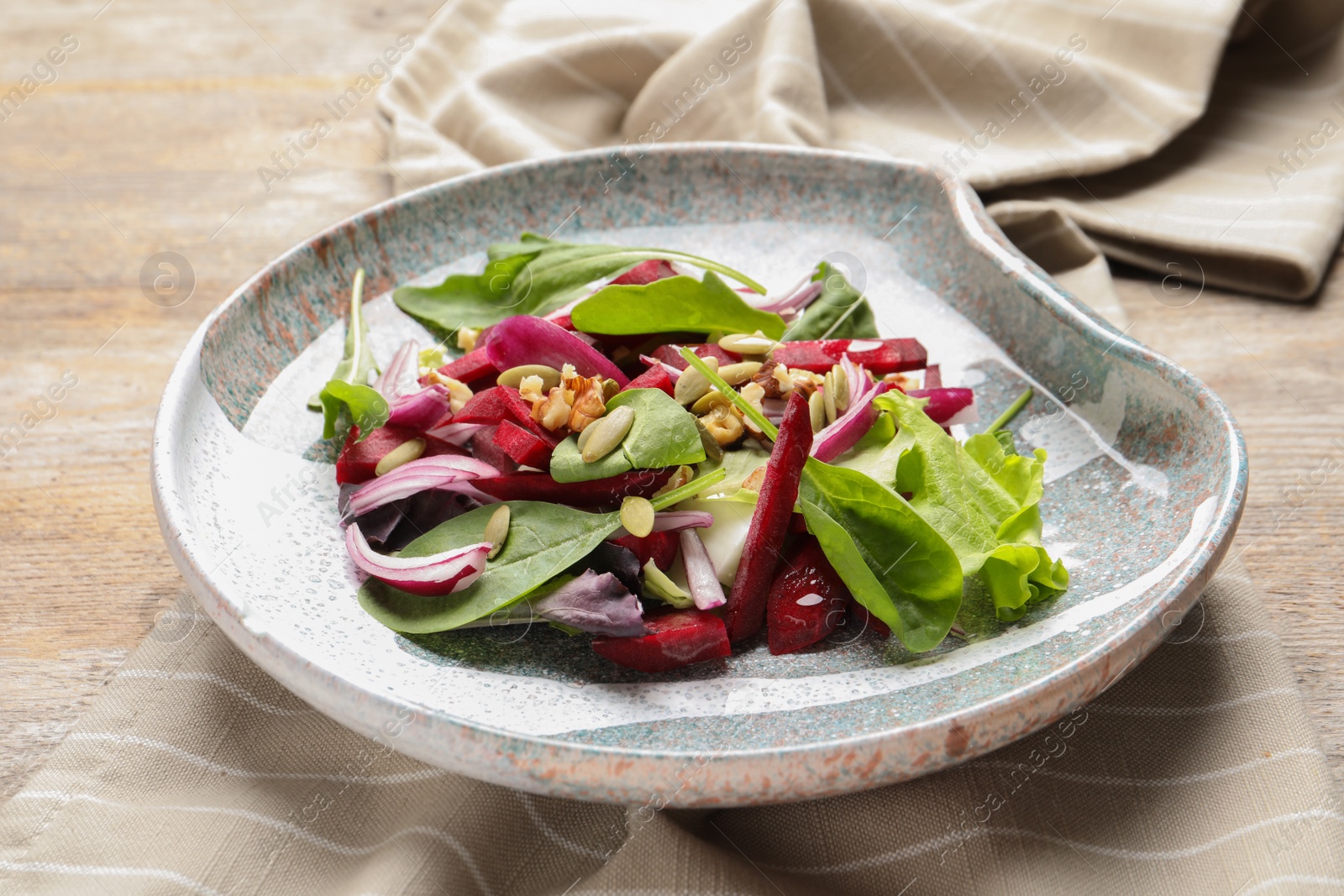 Photo of Plate with delicious beet salad served on table