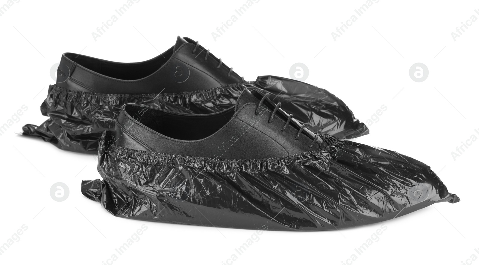 Photo of Men's shoes in black shoe covers isolated on white