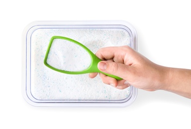 Photo of Woman holding scoop of laundry powder over container isolated on white, top view