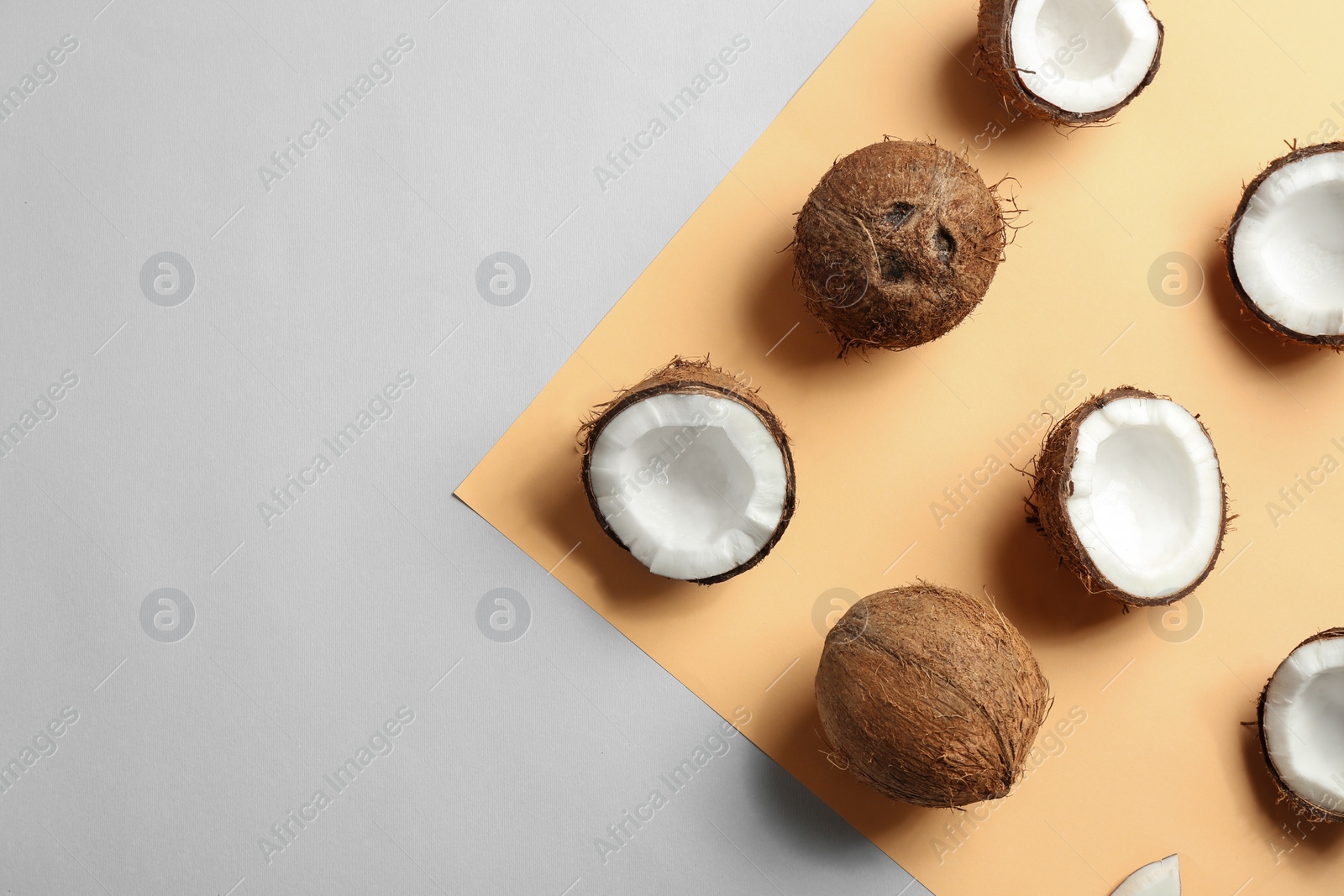 Photo of Flat lay composition with coconuts on color background. Space for text