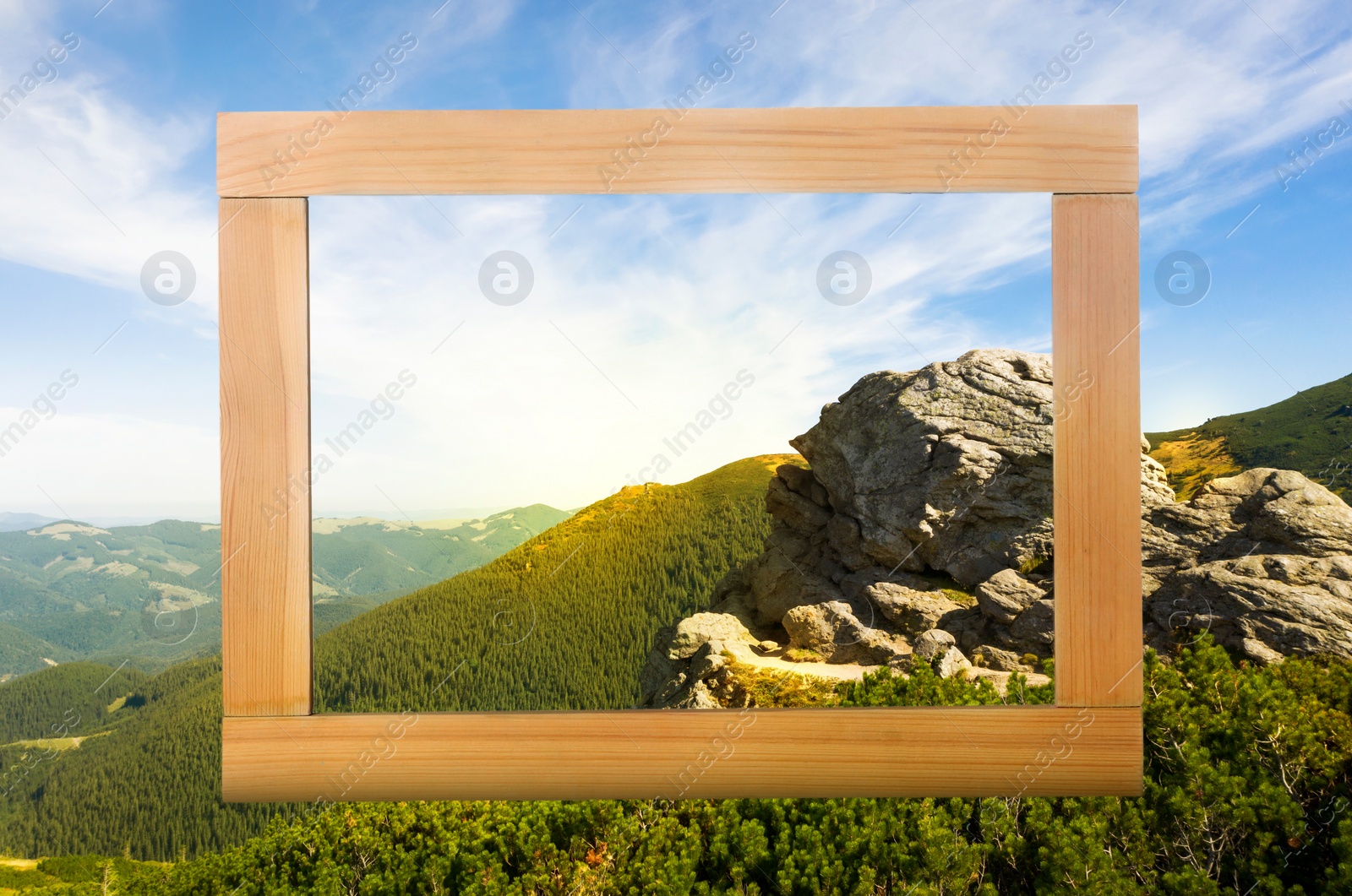 Image of Wooden frame and beautiful mountains under blue sky with clouds