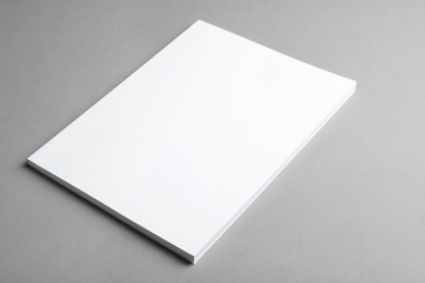 Photo of Brochure with blank cover on grey background. Mock up for design