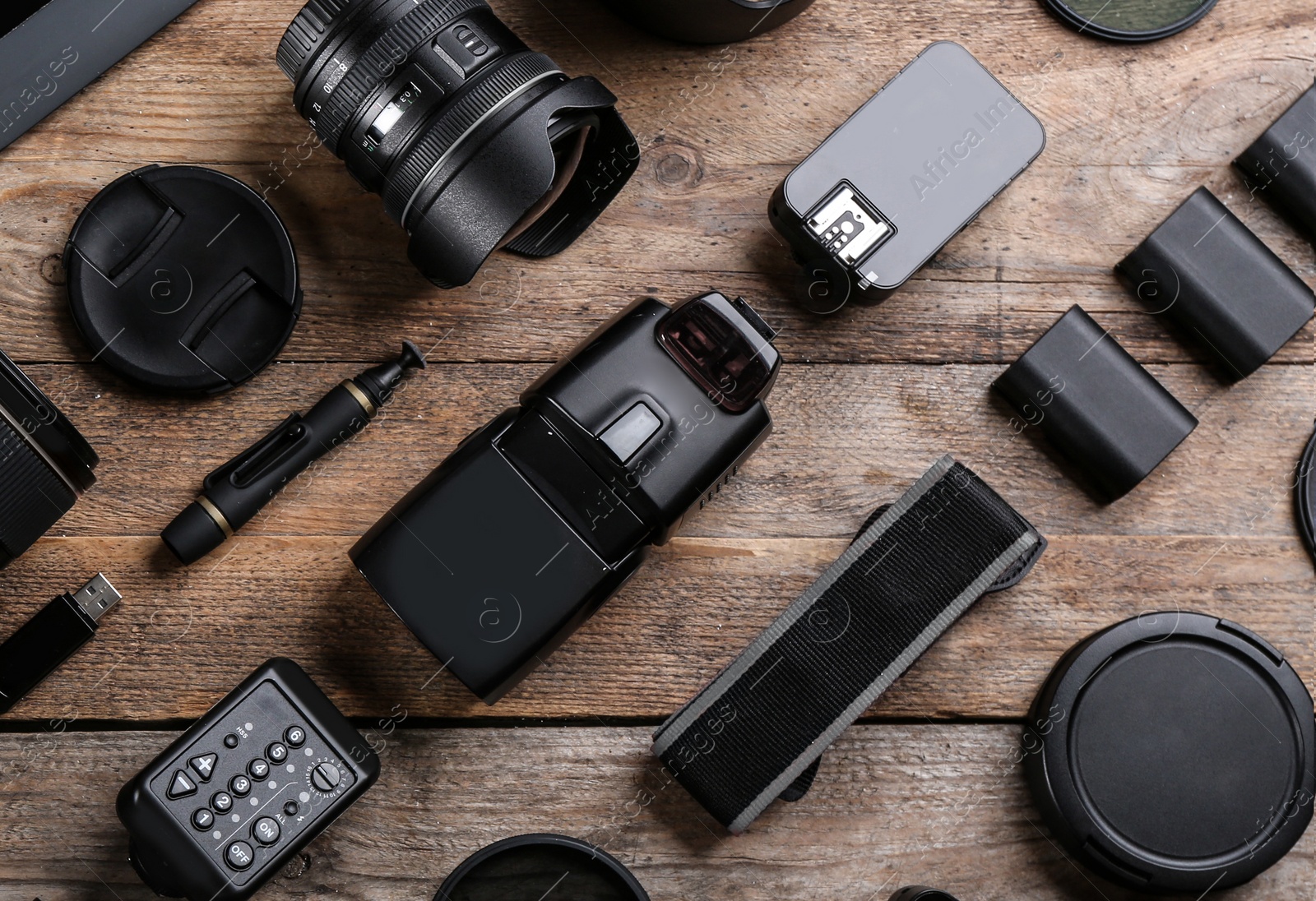 Photo of Flat lay composition with equipment for professional photographer on wooden table