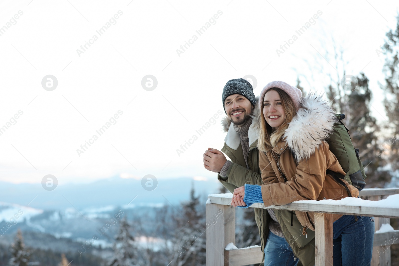 Photo of Couple spending winter vacation together in mountains. Space for text