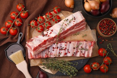 Photo of Flat lay composition with raw pork ribs and sauce on wooden table
