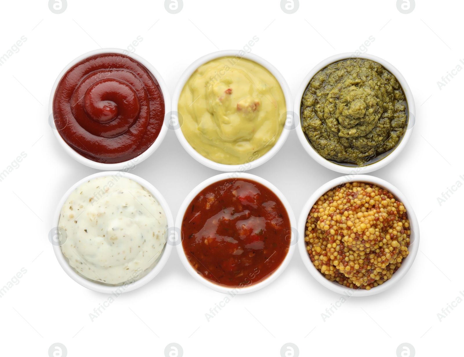 Photo of Many different sauces in bowls on white background, top view