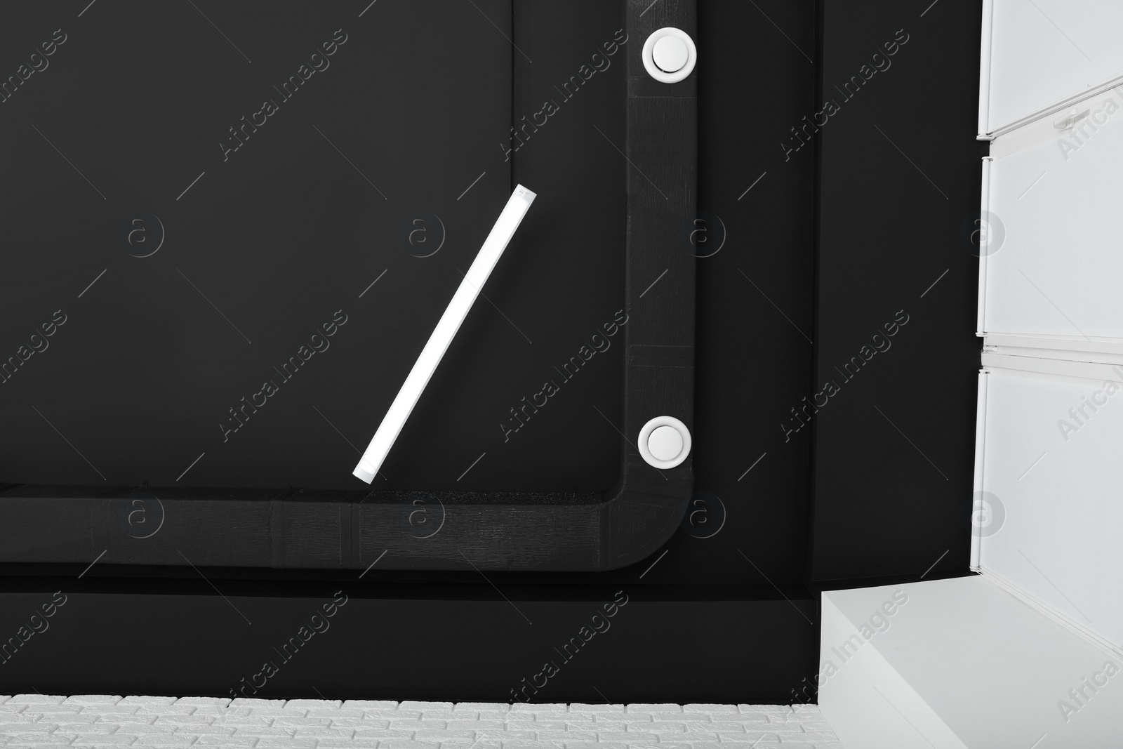 Photo of Black ceiling with modern lighting in room, bottom view