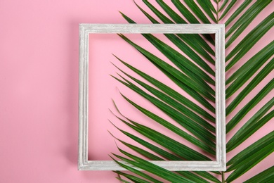 Flat lay composition with tropical leaves on color background