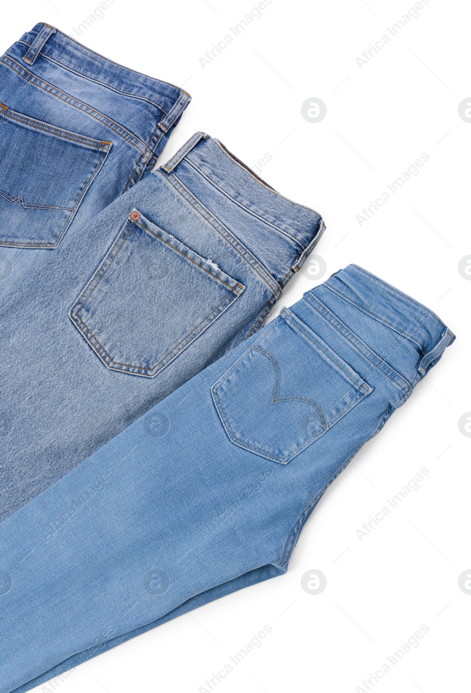 Photo of Different stylish jeans isolated on white, above view