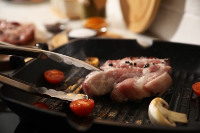 Photo of Frying pan with fresh raw meat and vegetables, closeup