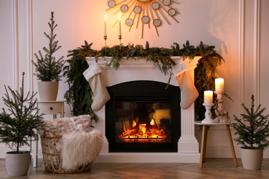 Stylish room interior with fireplace and beautiful Christmas decor