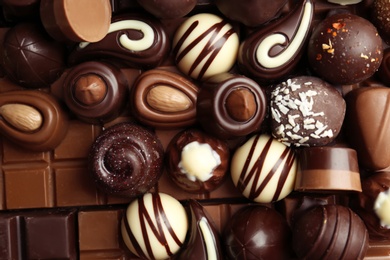 Photo of Many different tasty chocolate candies as background