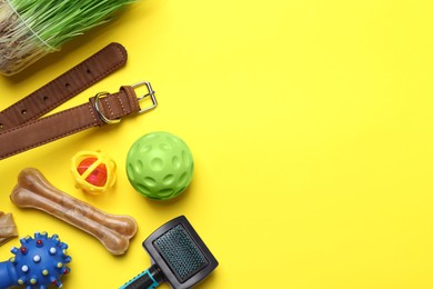 Flat lay composition with pet toys and accessories on yellow background, space for text