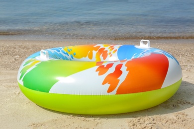 Photo of Bright inflatable ring near sea on sunny day