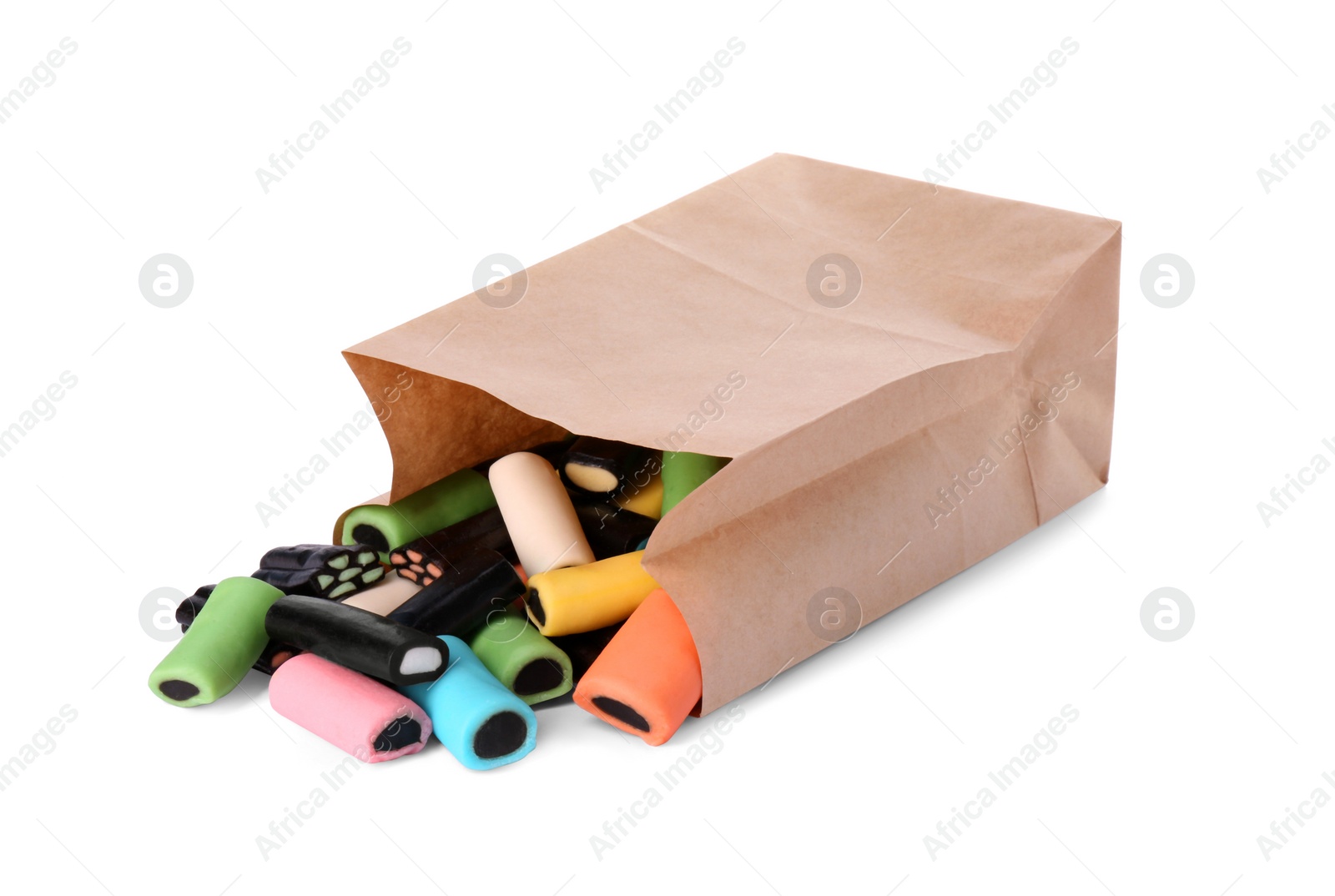 Photo of Paper bag with tasty liquorice candies isolated on white