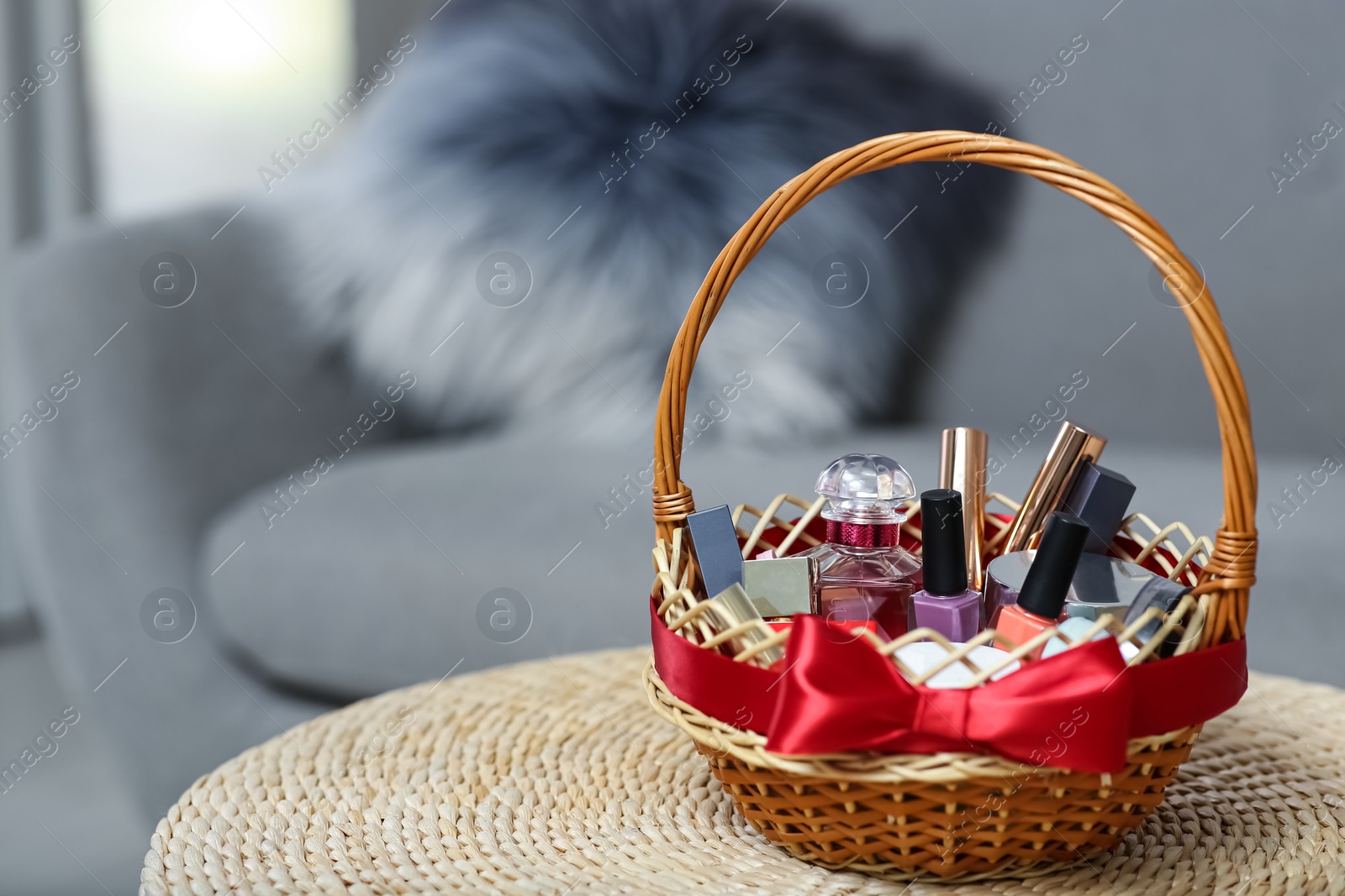 Photo of Wicker basket full of gifts in living room. Space for text