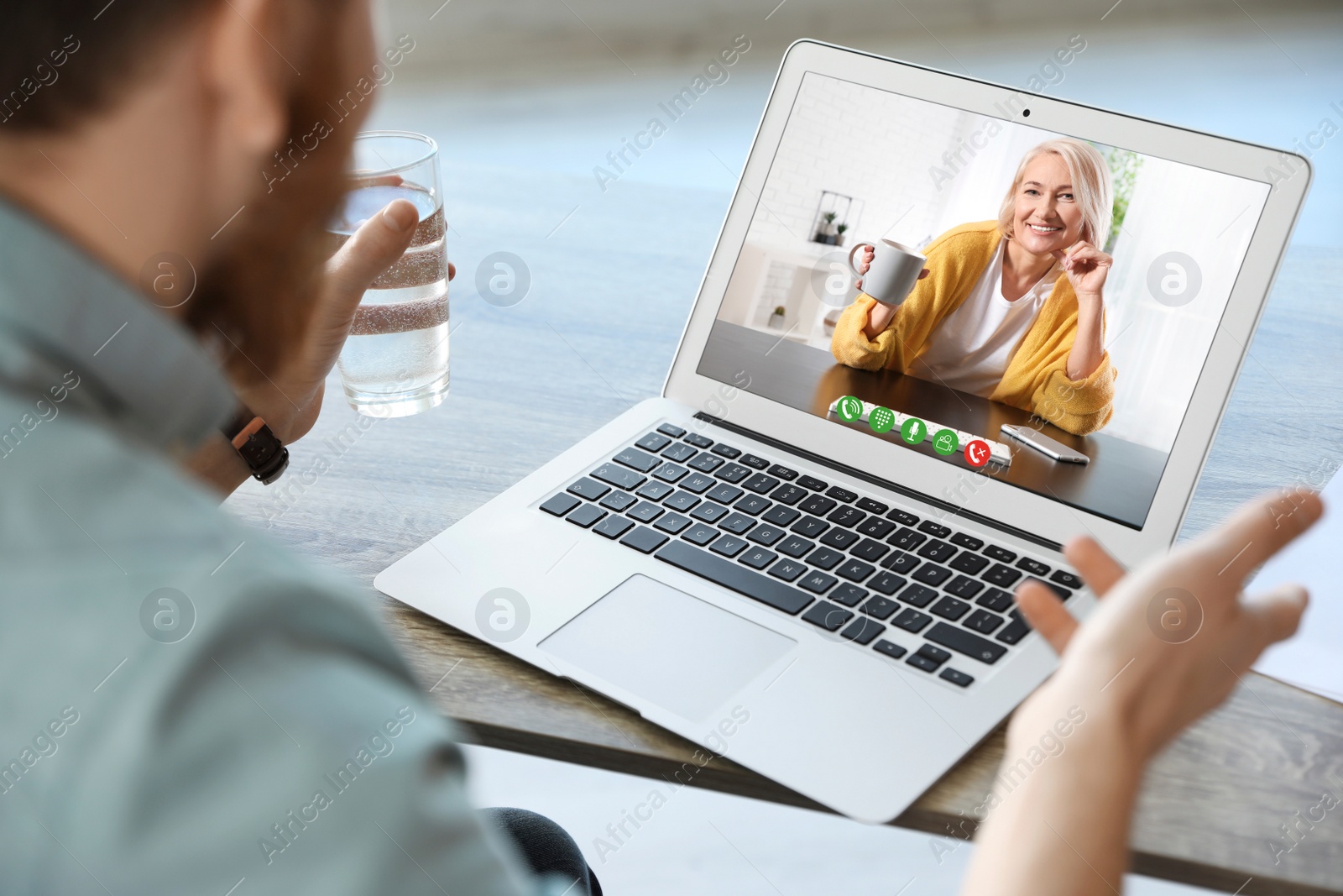 Image of Young man having video chat with his grandmother at home, focus on screen