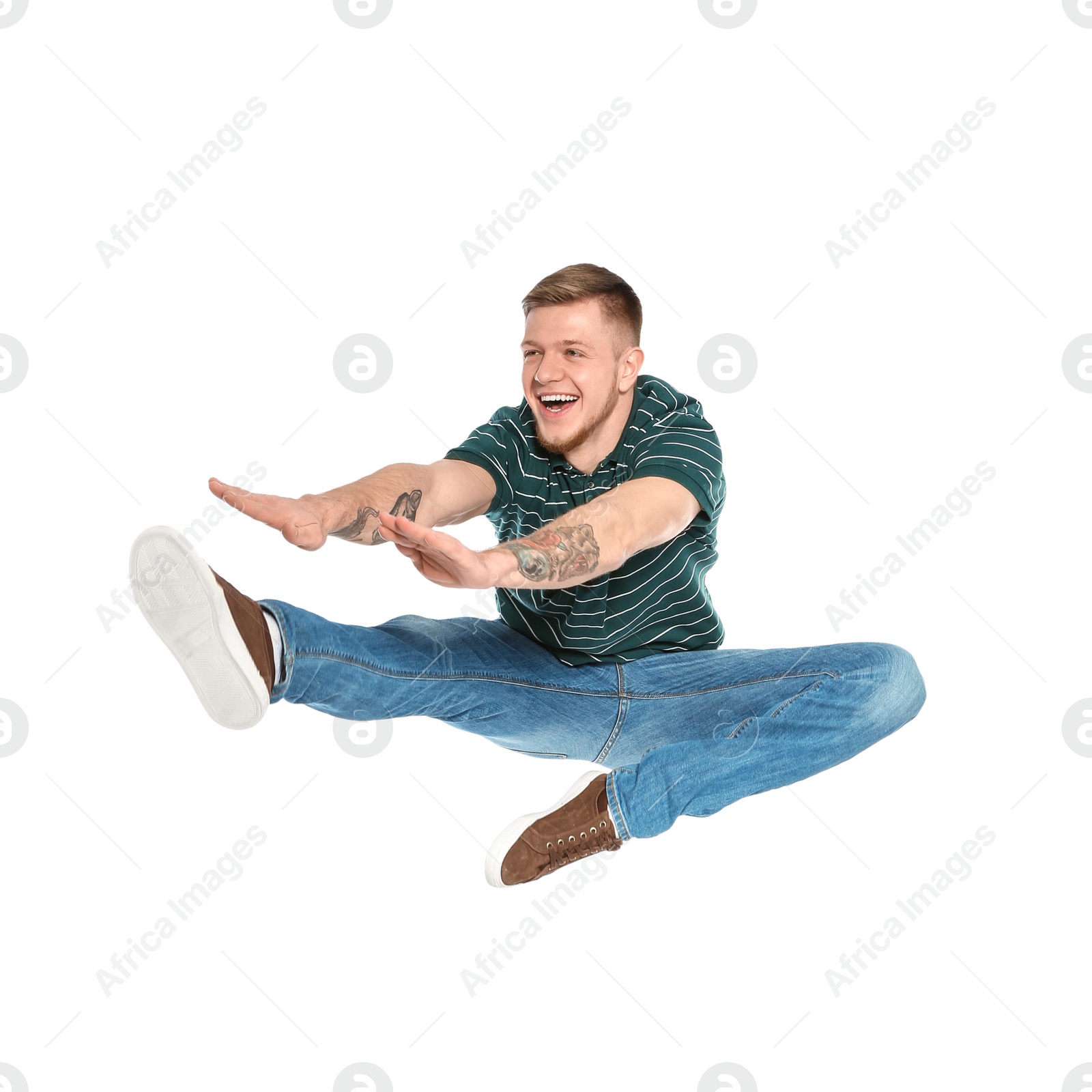 Photo of Handsome young man jumping on white background