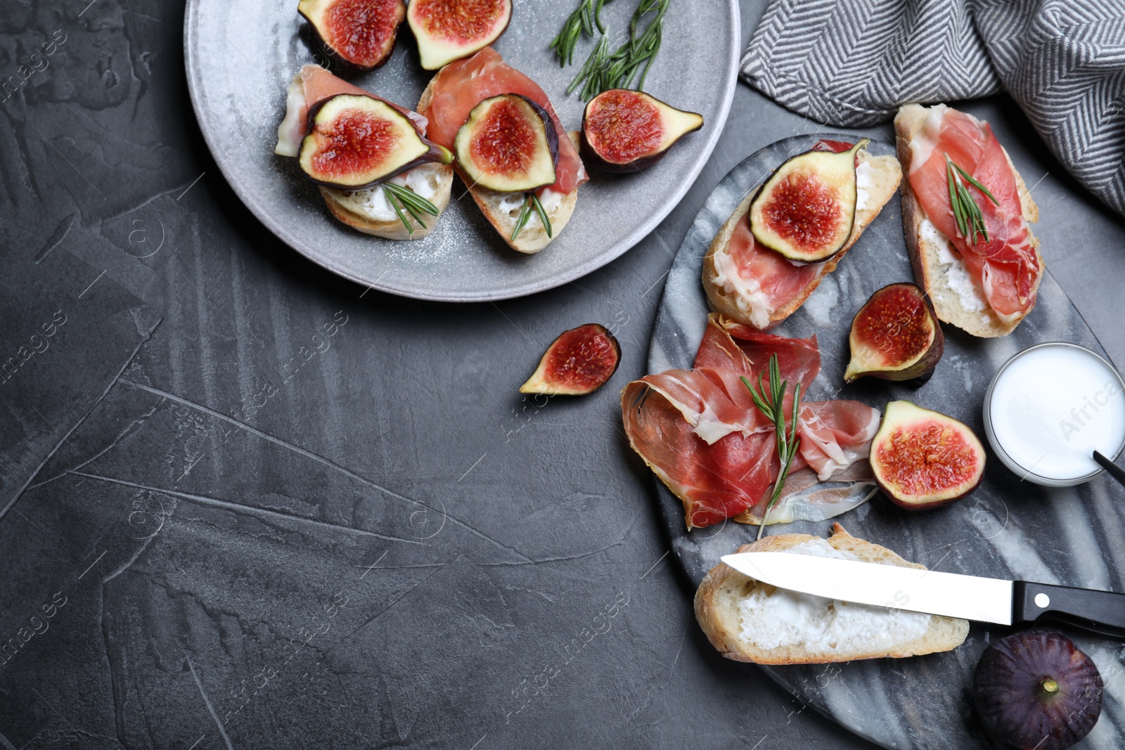 Photo of Sandwiches with ripe figs, cream cheese and prosciutto served on black table, flat lay. Space for text