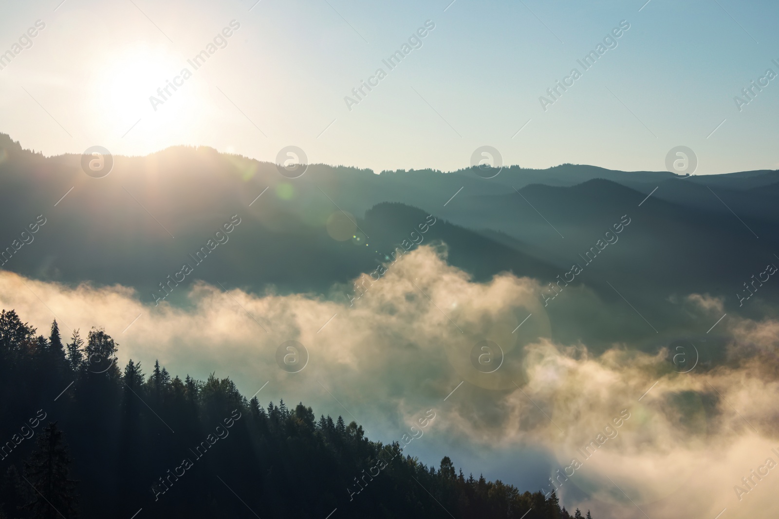 Photo of Beautiful view of mountains covered with fog at sunrise