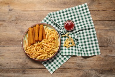 Tasty french fries, cheese sticks and ketchup on wooden table, top view