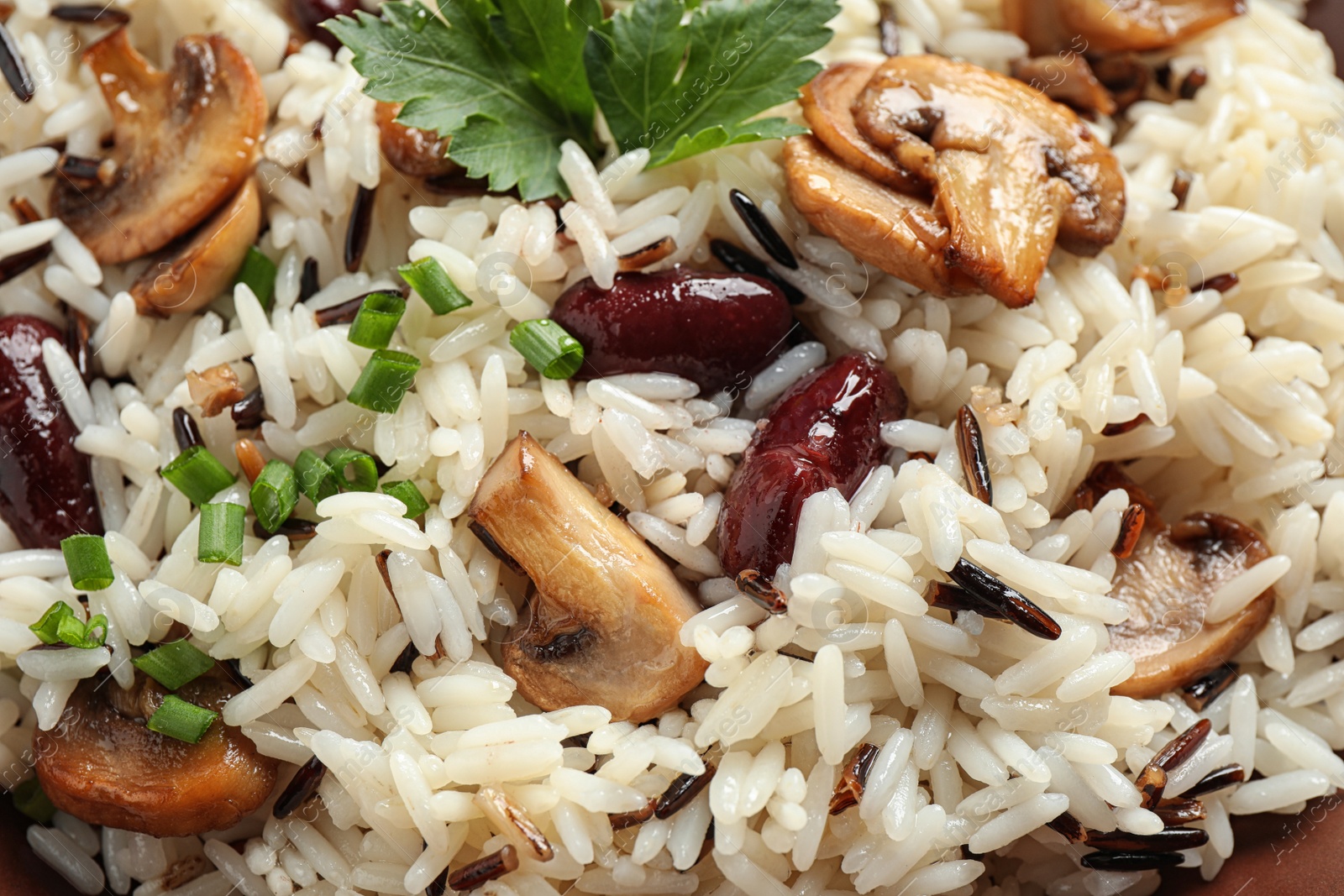 Photo of Delicious rice pilaf with beans and mushrooms as background, closeup