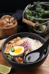 Photo of Eating delicious vegetarian ramen at wooden table