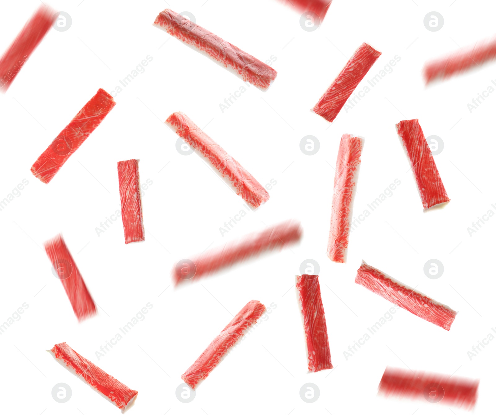 Image of Many fresh crab sticks falling on white background