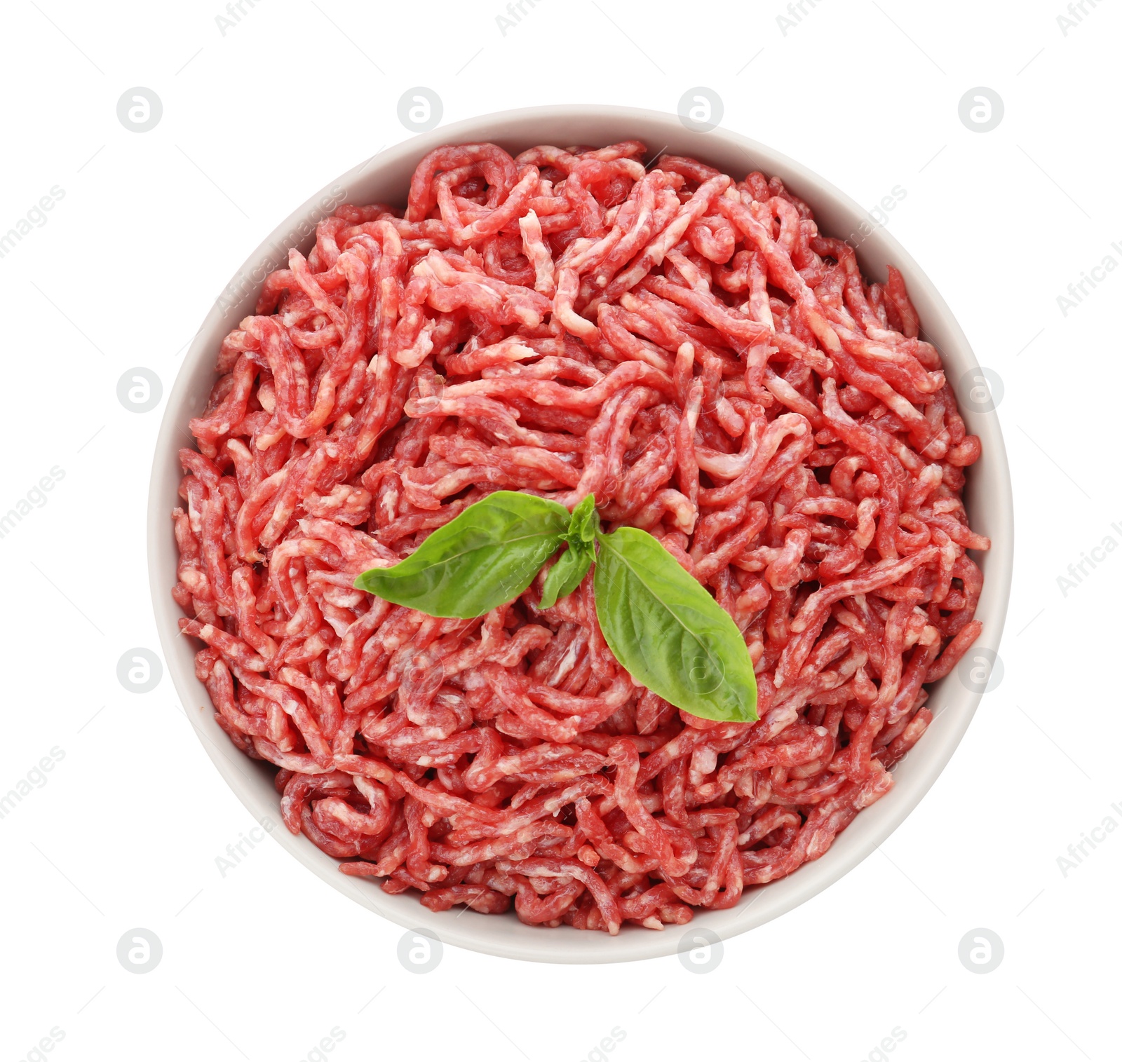 Photo of Bowl of raw minced meat with basil on white background, top view