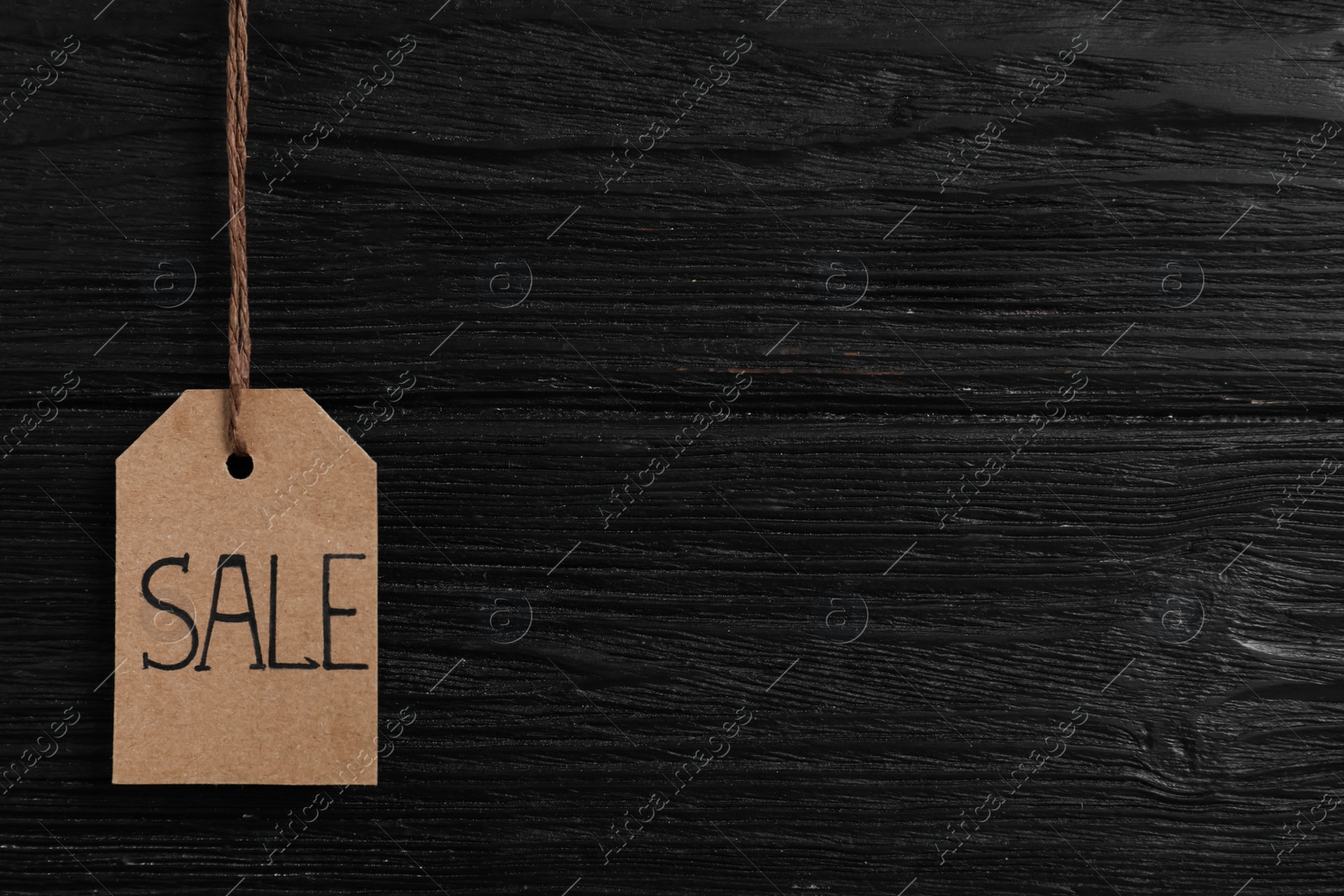 Photo of Sale tag on wooden background, space for text. Black Friday concept