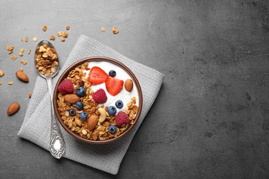 Photo of Tasty homemade granola  served on grey table, flat lay with space for text. Healthy breakfast