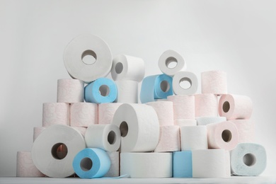 Pile of toilet paper rolls on white background