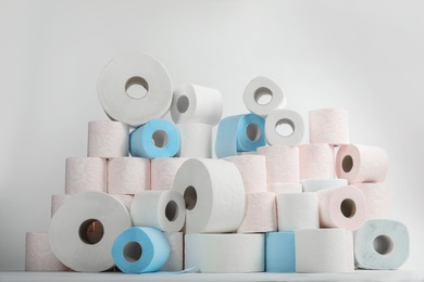 Photo of Pile of toilet paper rolls on white background