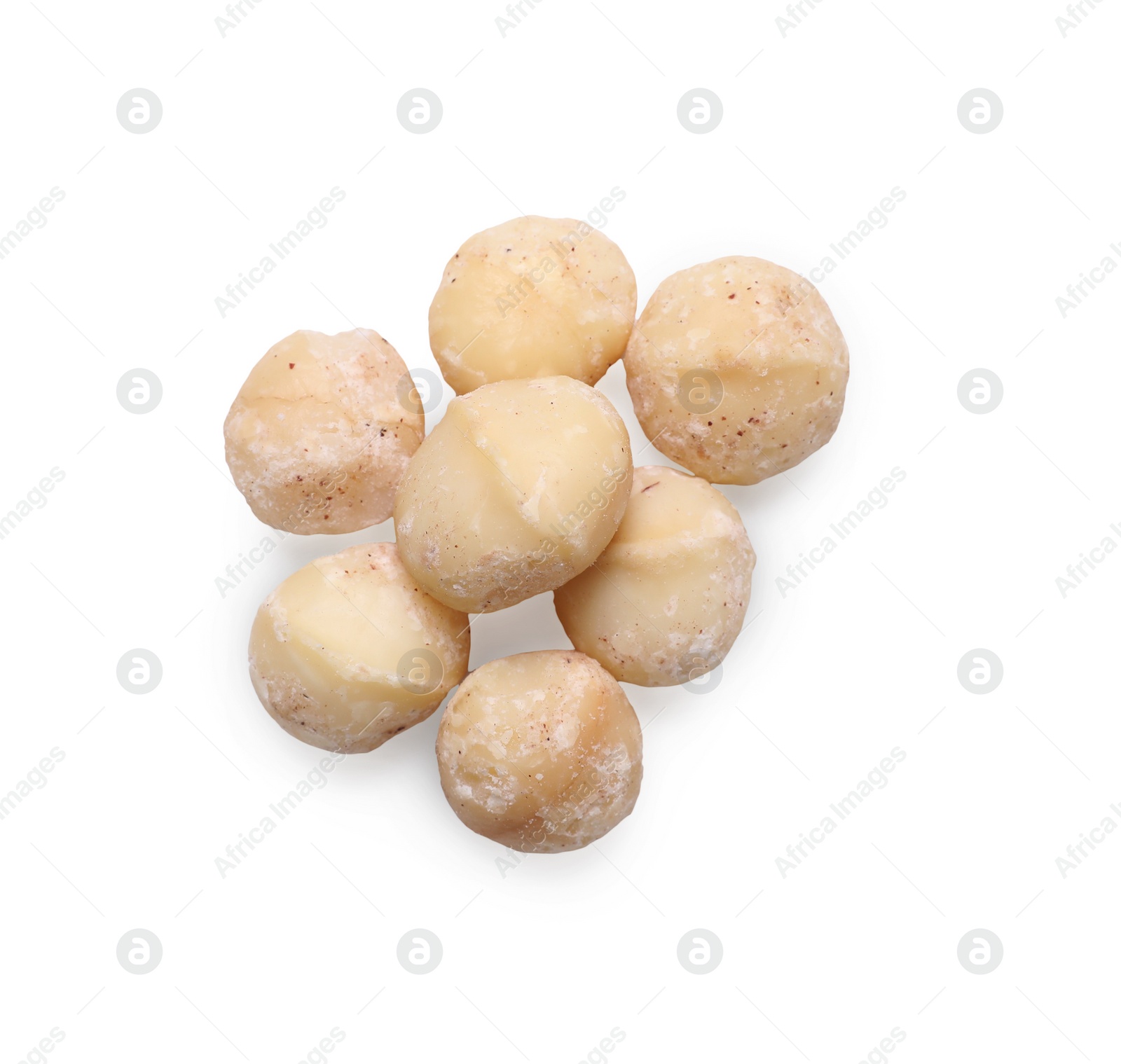Photo of Delicious shelled Macadamia nuts isolated on white, top view