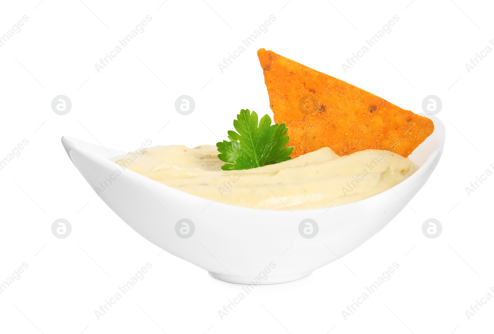 Photo of Delicious hummus with nacho chip and parsley in bowl isolated on white