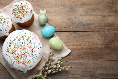 Flat lay composition with Easter cakes on wooden table. Space for text