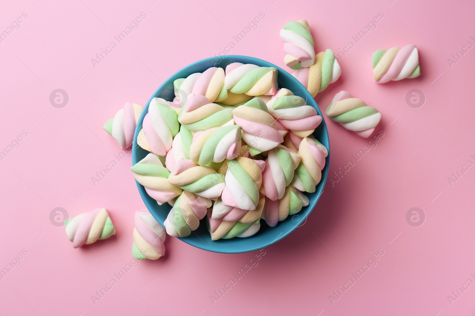 Photo of Bowl with delicious colorful marshmallows on pink background, flat lay