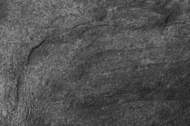 Texture of dark grey stone surface as background, closeup