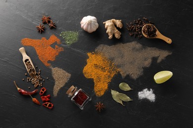 Photo of World map of different spices and products on dark textured table, flat lay