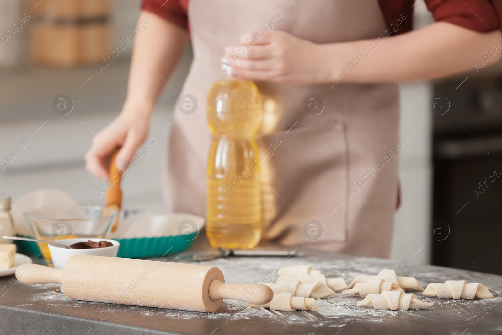 Photo of Raw croissants and woman on background