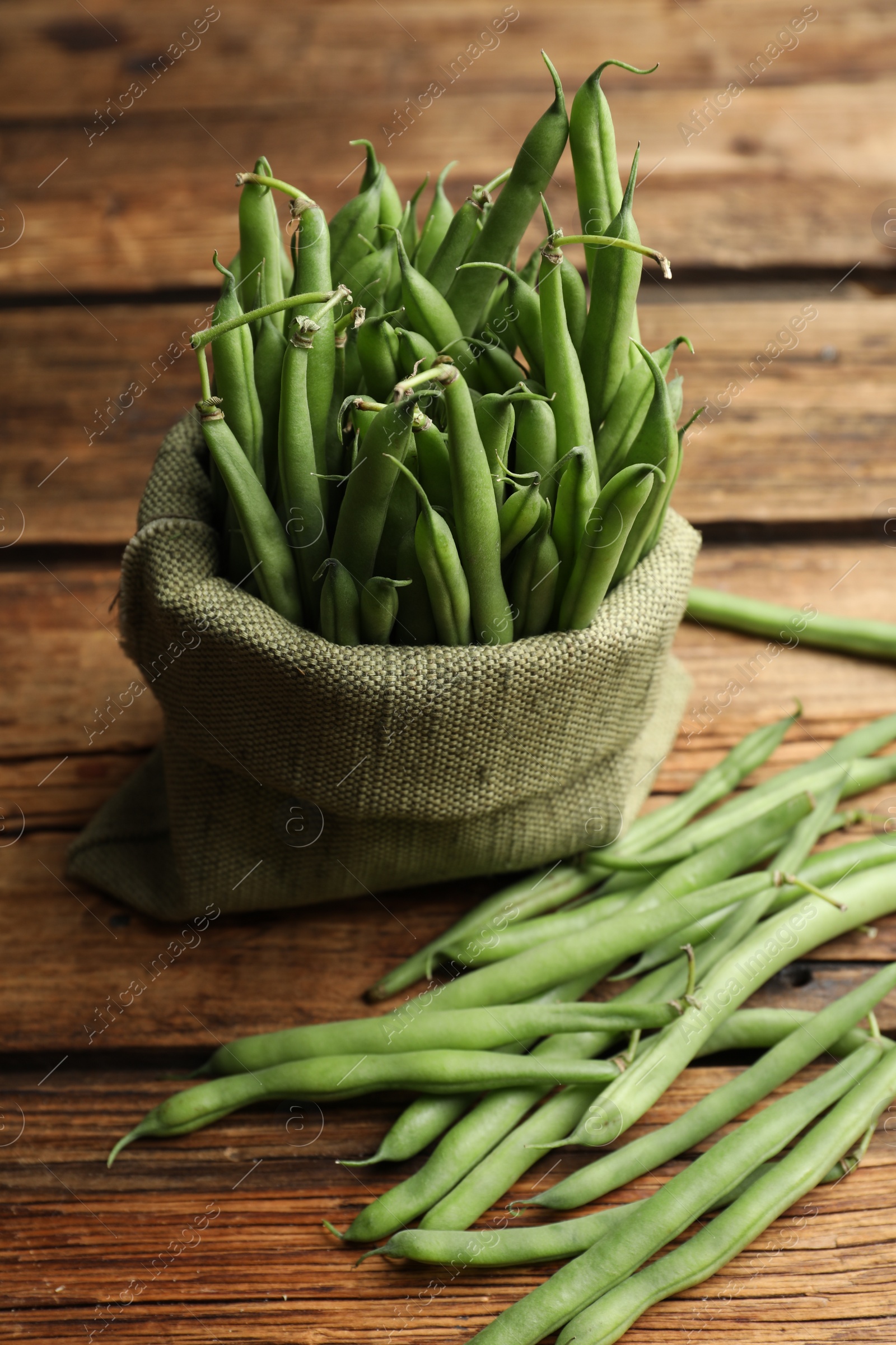 Photo of Delicious fresh green beans on wooden table