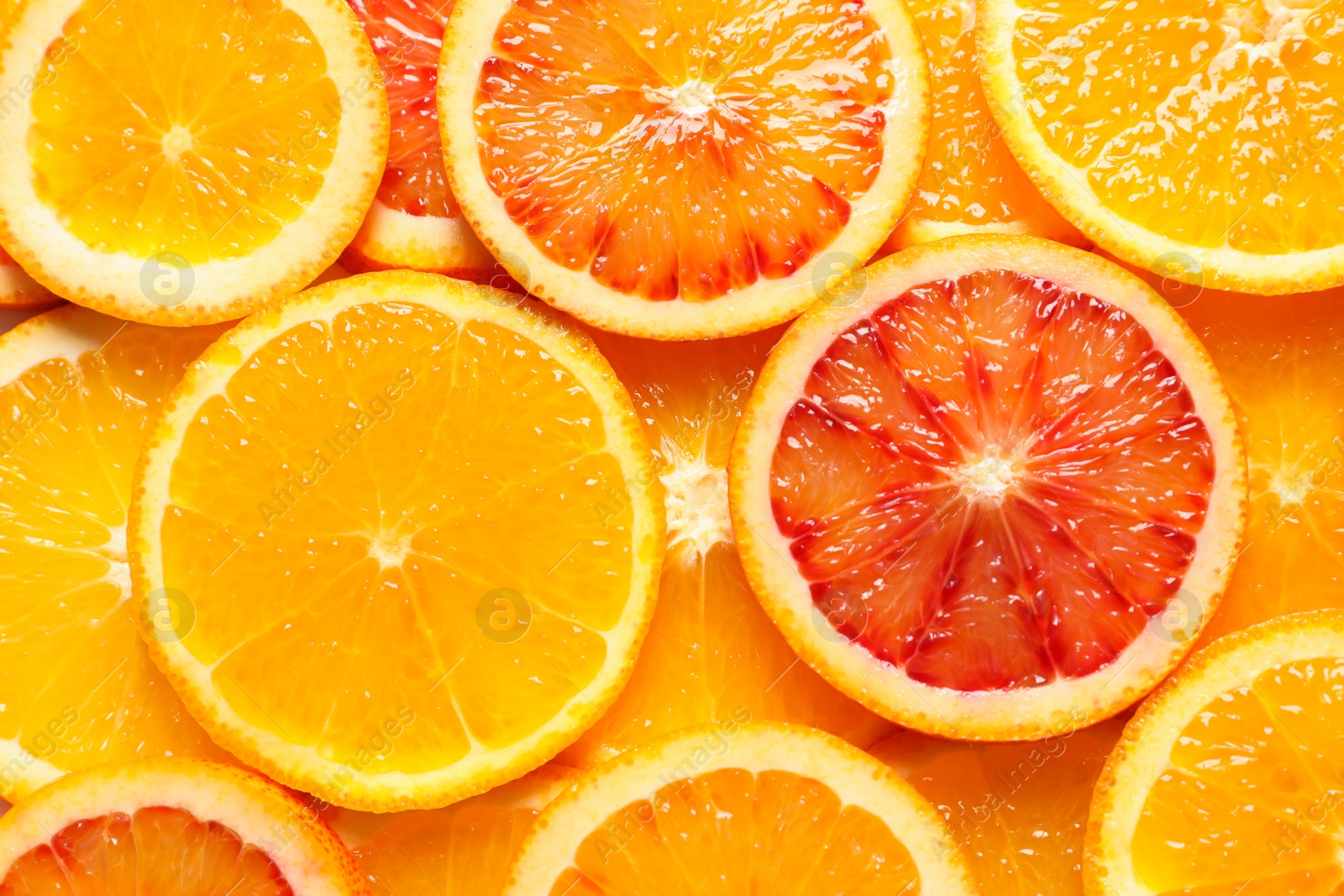 Photo of Slices of fresh citrus fruits as background, top view