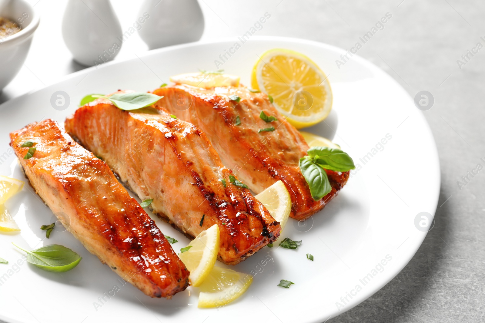 Photo of Plate with tasty freshly cooked salmon, closeup