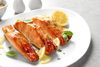 Photo of Plate with tasty freshly cooked salmon, closeup